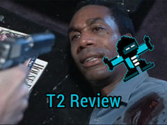 Terminator 2 Review: A white person points a gun at T2 character Miles Dyson, a black man