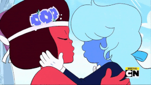 An animated GIF of a scene from the 2-part episode "Reunited" (151 and 152). Ruby and Sapphire, colored like their respective namesakes, embrace and kiss. Ruby is wearing a traditional women's wedding dress and Sapphire is wearing a traditional men's tuxedo.