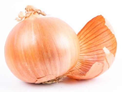 A photo of an onion with skin peeling off.