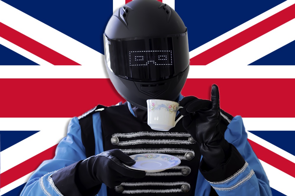 BroBot sips tea in front of the Union Jack.